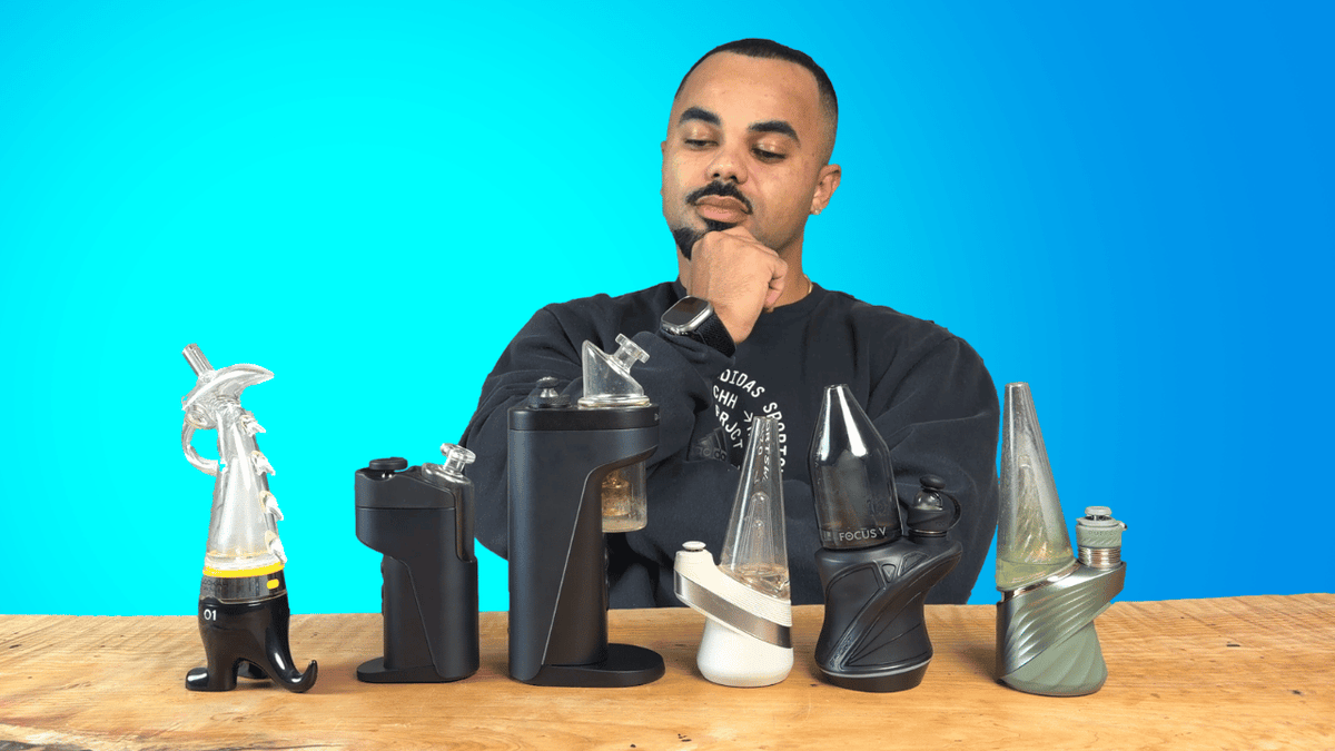 Riley sitting at table with all of his best electric dab rigs