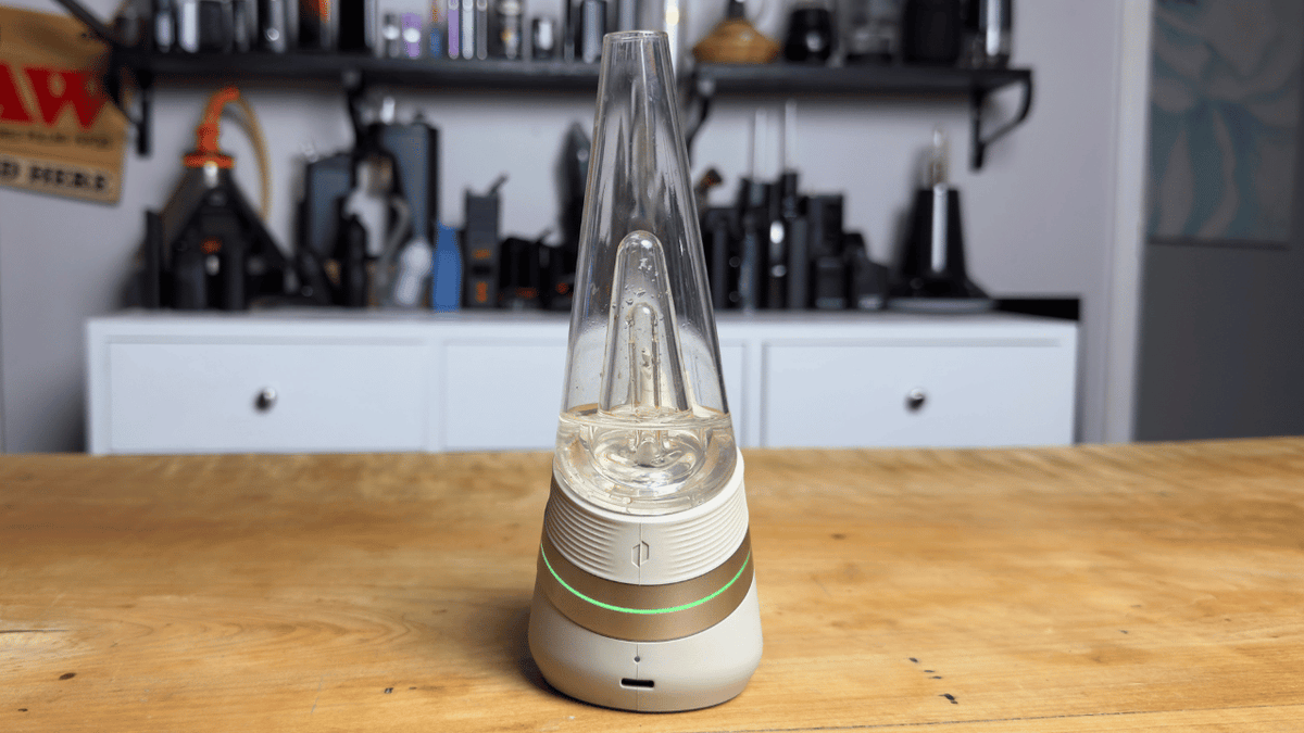 Picture of Puffco New Peak from the front and the green light is on indicating it is on the green heating setting