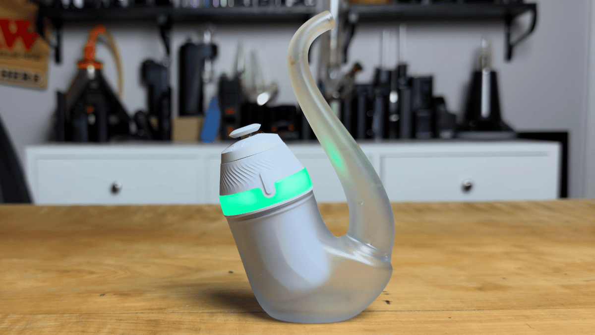 Picture of Puffco New Proxy on green heating setting while it sits on table