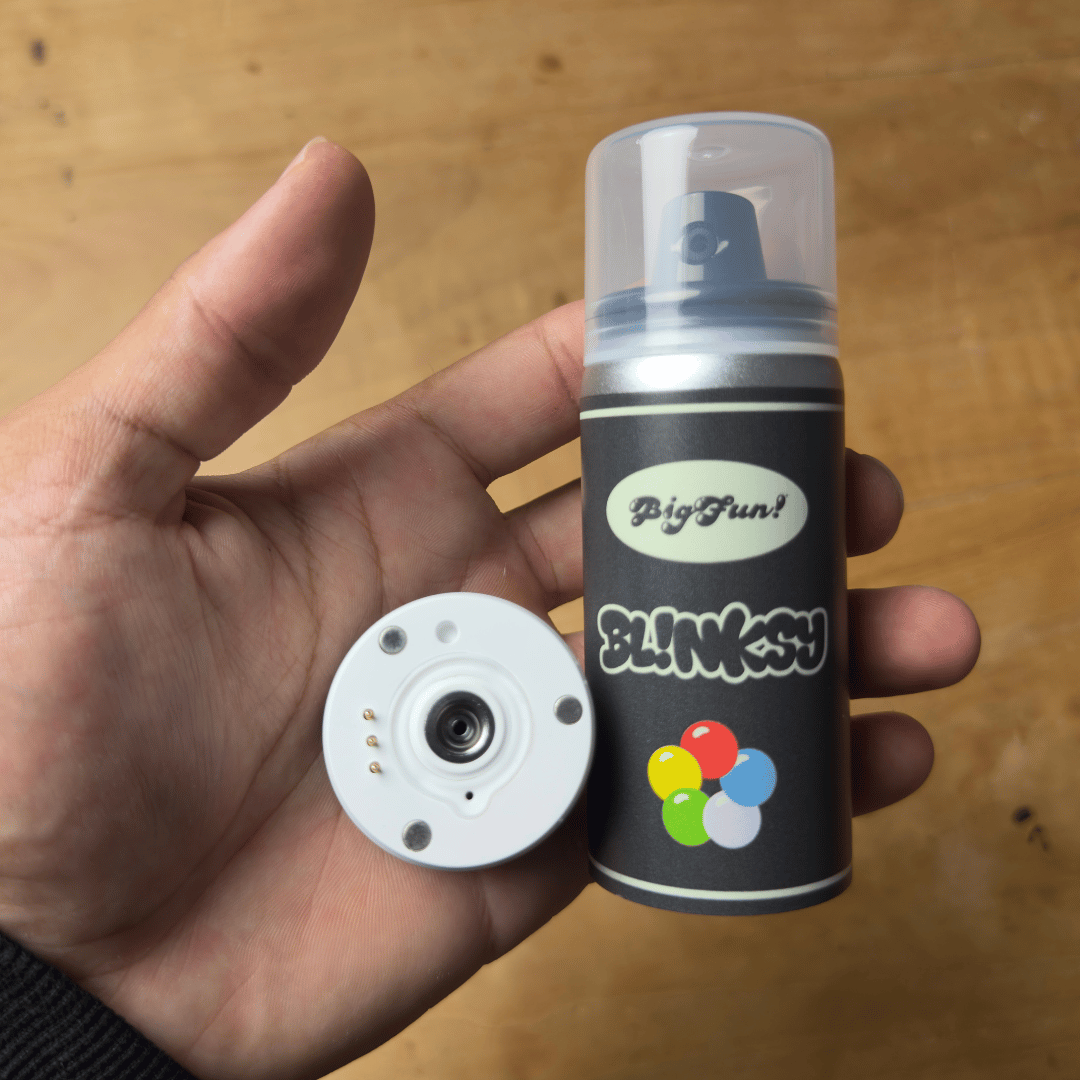 Bigfun! Blinksy 510 Battery - Compact black Bigfun! Blinksy 510 battery with colorful flower graphics and a clear protective cap, held beside a white.