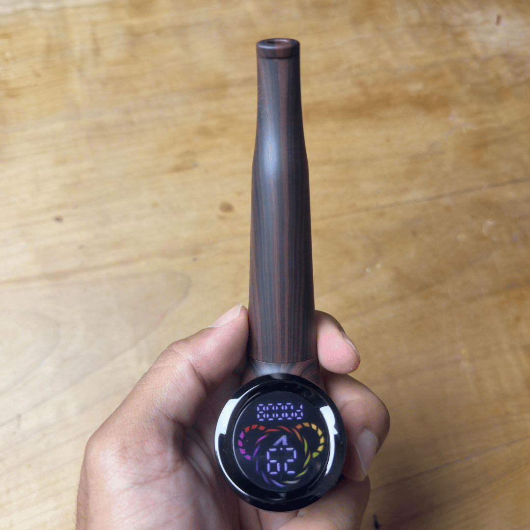Cartisan The Inspector 510 Vaporizer Battery - Dark brown Cartisan Inspector 510 vaporizer battery with a tapered body and round digital display, held in hand.