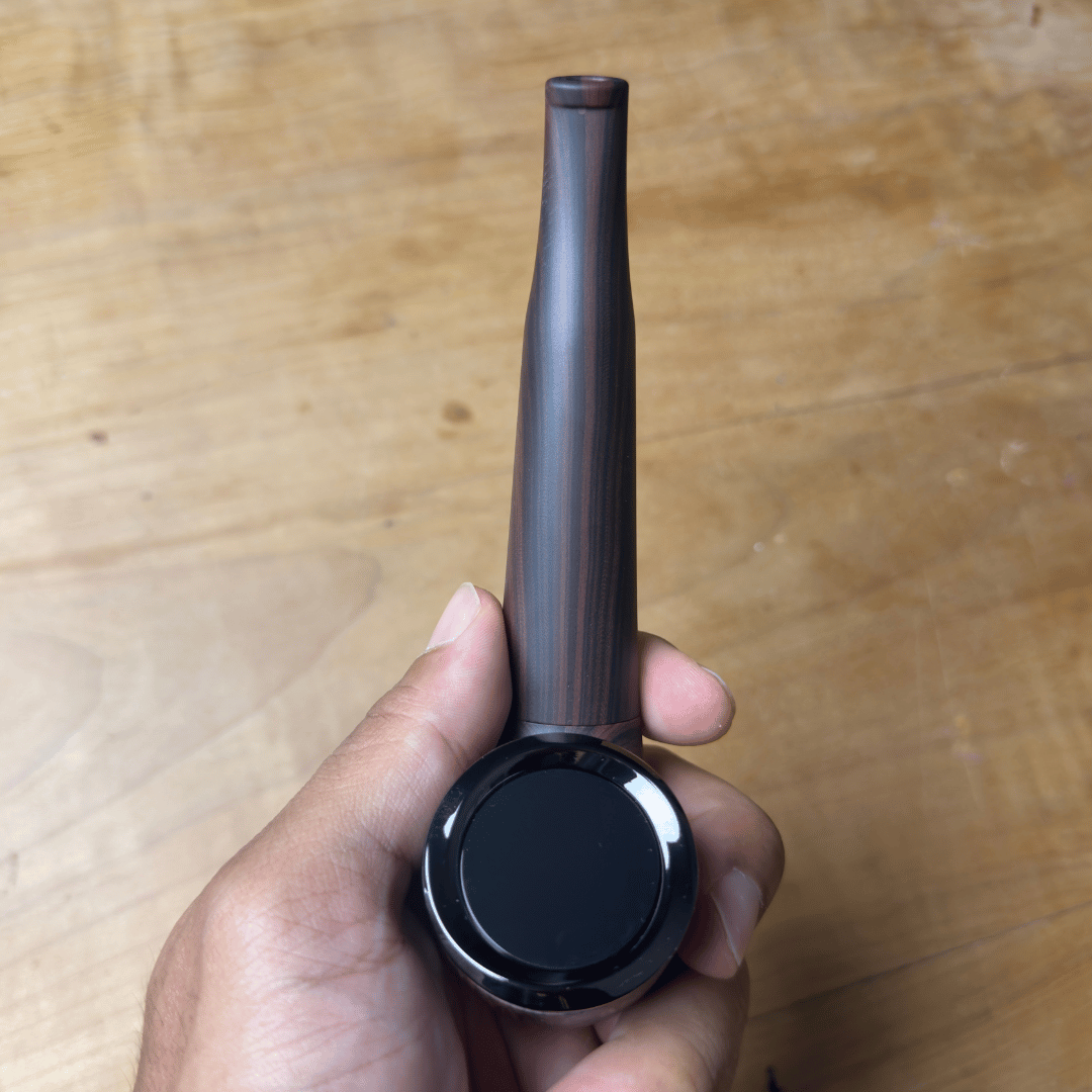 Cartisan The Inspector 510 Vaporizer Battery - Slim black 510 vaporizer battery with a long tapered mouthpiece and round display, held in hand.