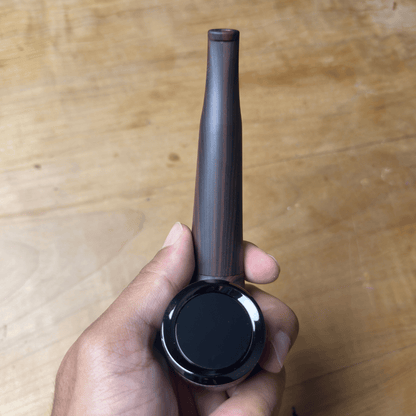 Cartisan The Inspector 510 Vaporizer Battery - Slim black 510 vaporizer battery with a long tapered mouthpiece and round display, held in hand.