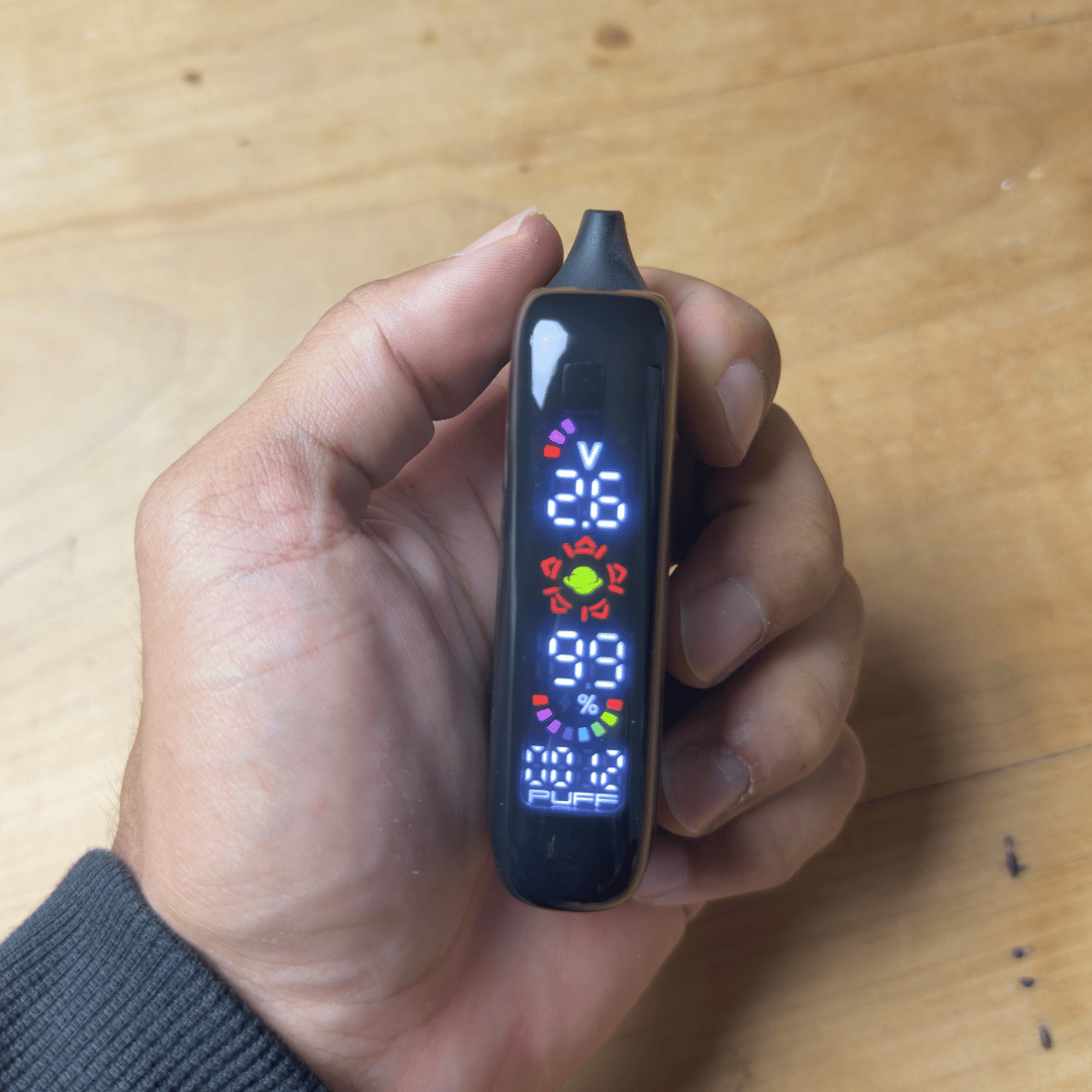 Cartisan Veil Bar Pro Evo 510 Battery - Black Veil Bar Pro Evo battery held in hand, with a slim rectangular body and colorful digital display.