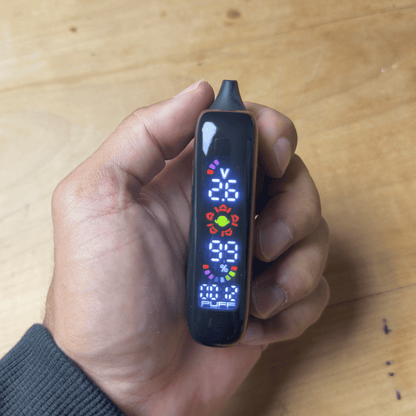 Cartisan Veil Bar Pro Evo 510 Battery - Black Veil Bar Pro Evo battery held in hand, with a slim rectangular body and colorful digital display.