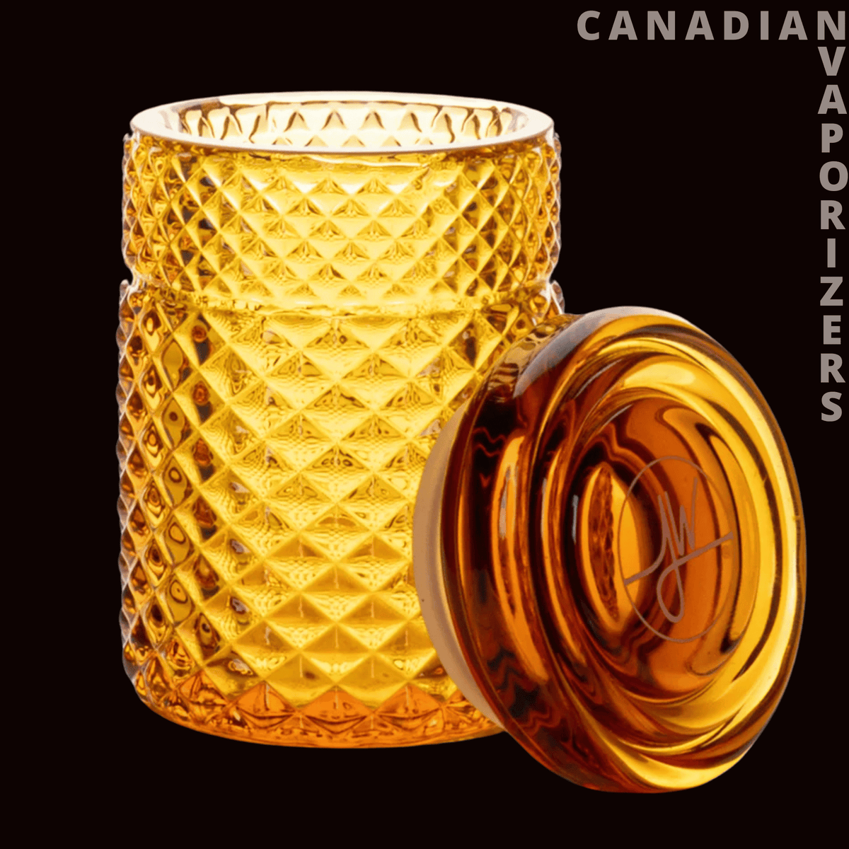 Jane West 3" Twenties Collection Stash Jar - Amber glass stash jar with a diamond-cut texture and matching round lid leaning beside it.