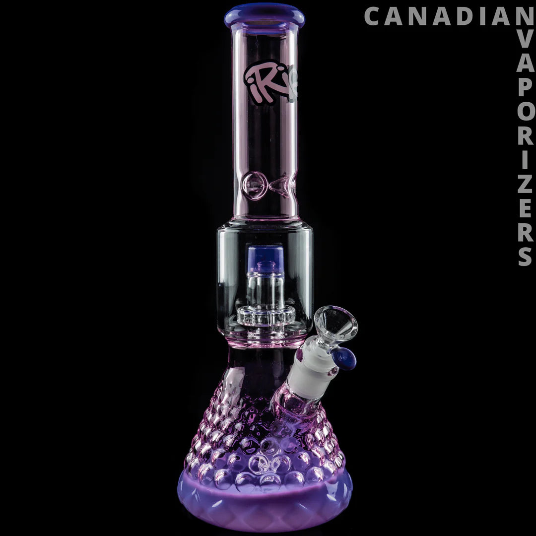 iRie | 13.5" Dual Chamber Beaker Tube - Purple glass dual-chamber beaker bong with a tall tube, patterned base, and angled side bowl.