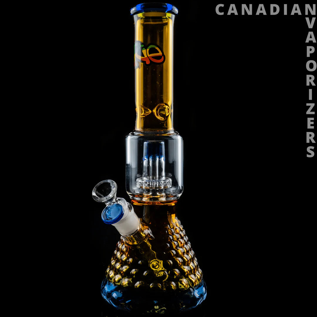 iRie | 13.5" Dual Chamber Beaker Tube - Sapphire blue and amber glass dual-chamber beaker bong with a patterned base and angled bowl.