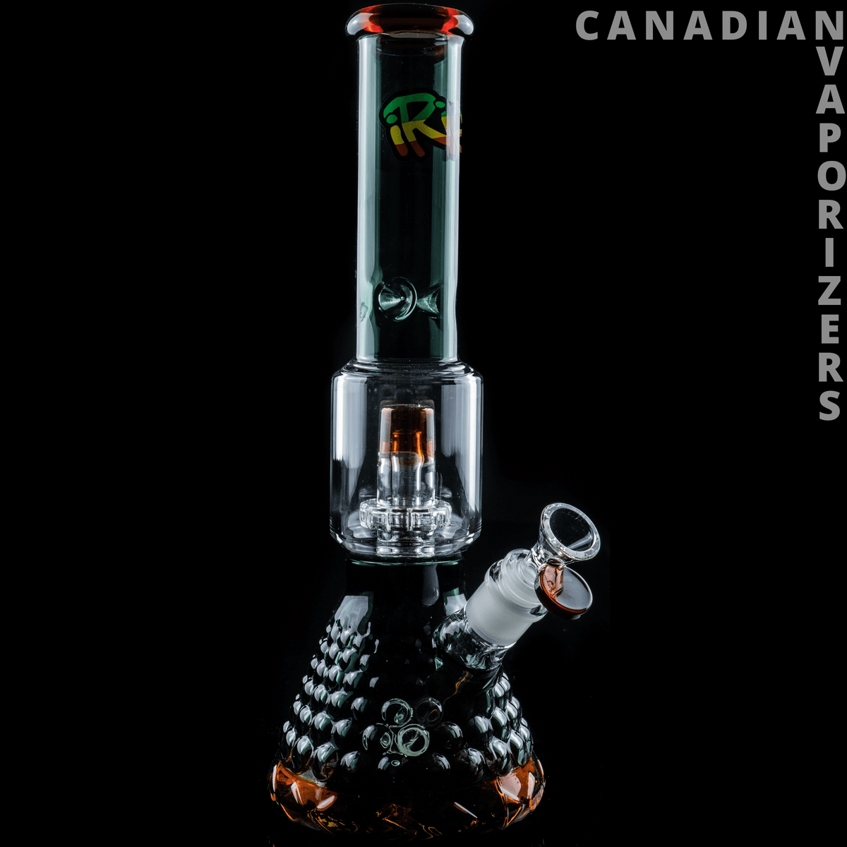 iRie | 13.5" Dual Chamber Beaker Tube - Sapphire blue glass dual-chamber beaker bong with textured black base and angled bowl attachment.