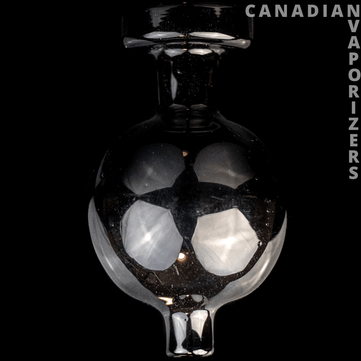 Black Carb Cap - Black glass carb cap with a rounded chamber, two pale circular inserts, and a narrow stem.