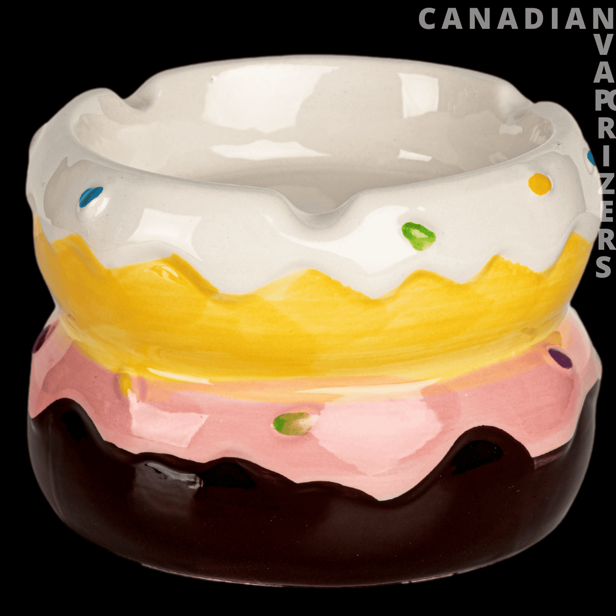 Donut Ashtray - Glossy ceramic donut ashtray with white icing, yellow and pink frosting bands, and chocolate-brown base.
