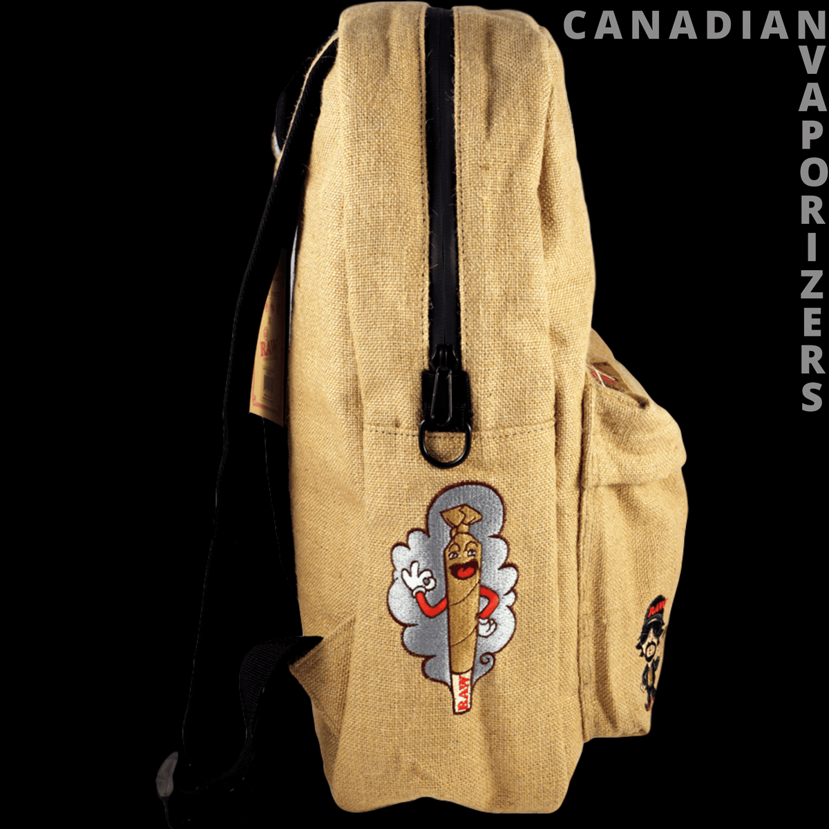Raw Backpack - Tan canvas backpack with black straps, side pockets, and a colorful cartoon character patch.