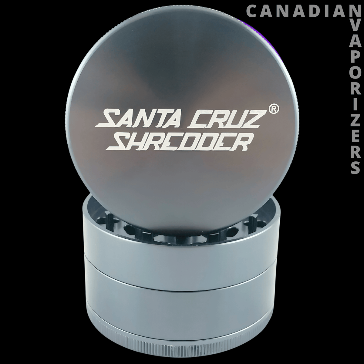Santa cruz shredder large 4-piece pollinator 2.75" - Gunmetal gray Santa Cruz Shredder with branded lid open, revealing grinder teeth.
