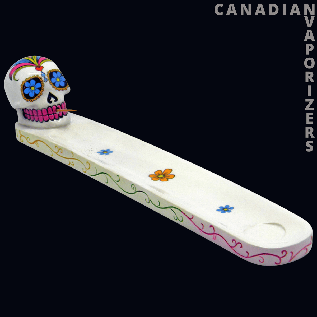 Skull Incense Holder - White ceramic skull incense holder with colorful floral decorations and a long curved ash-catching tray.