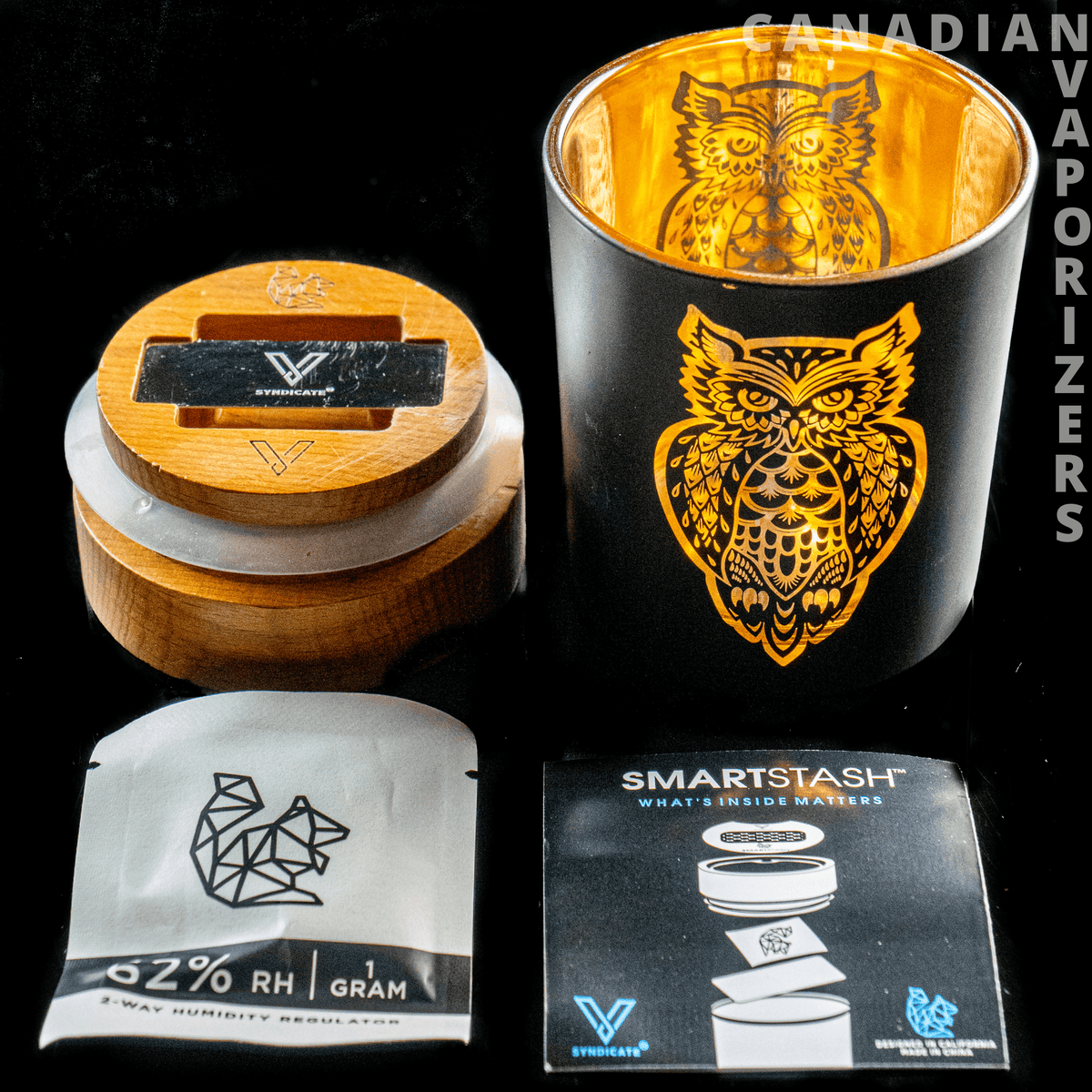 V-Syndicate Hamsa Smart Stash Jar - Grinder and Stash Jar - Black smart stash jar with gold owl artwork beside a wooden-lid grinder and product packaging.